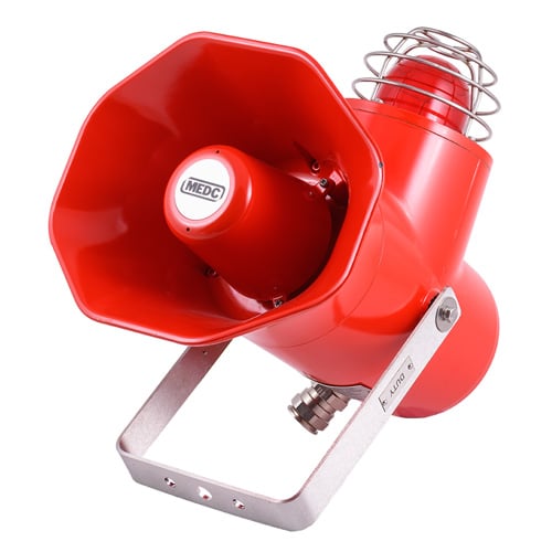 Red industrial alarm siren with a metal mounting bracket and protective cage.