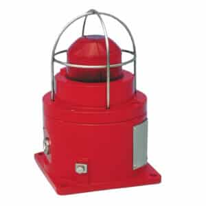 Red industrial warning light with a metal protective cage on a square base.