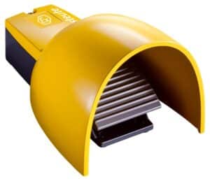 Yellow industrial foot pedal with a protective cover.