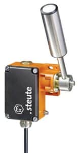 Industrial limit switch with an orange and black housing and a metal lever arm.