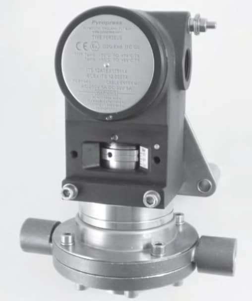 Industrial differential pressure sensor with circular housing and metal fittings.