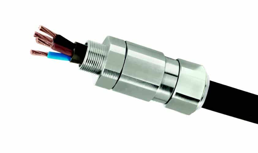 Metal cable gland connected to a black electrical cable with exposed copper wires.