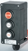 Black industrial control station with three buttons labeled Start, Stop, and Emergency.